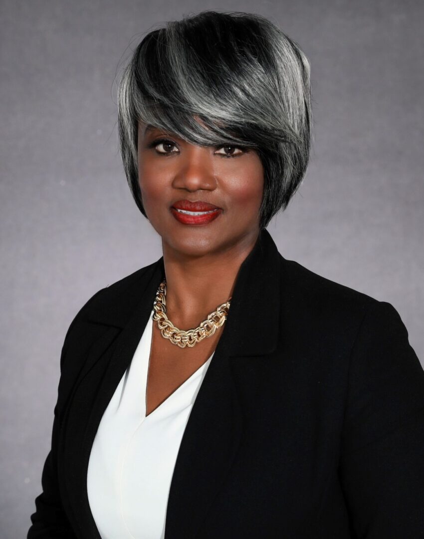 A woman with short hair and wearing a black jacket.