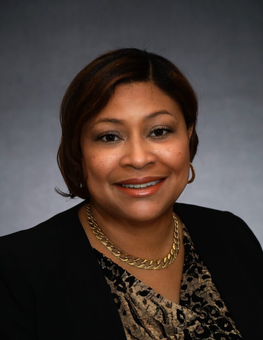 A woman with short hair wearing a black jacket.